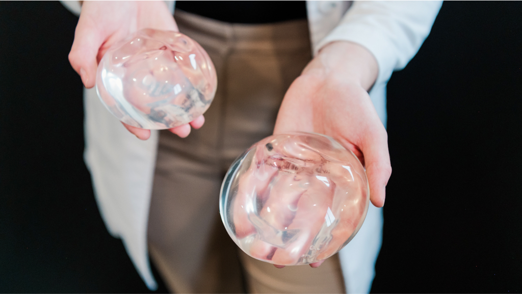 a woman holding breast augmentation implants