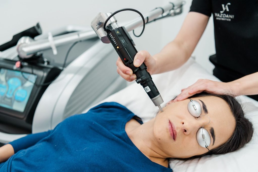 A woman receiving a facial laser treatment for pigmentation.